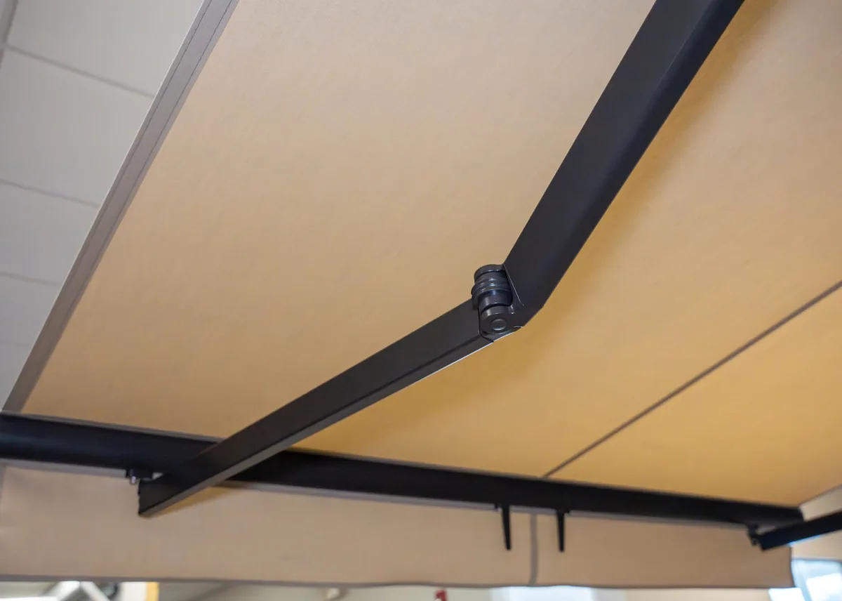 SunPro Open-Roll motorized awning extended over a wooden deck in Northwest Arkansas