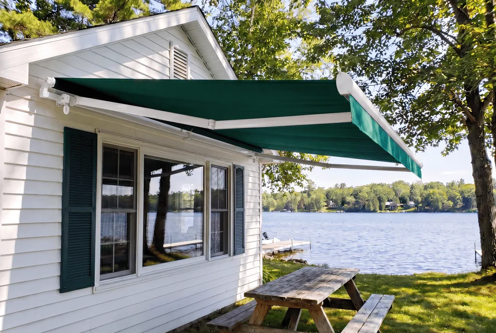 SunPro Open-Roll motorized retractable awning in green shading a Northwest Arkansas patio