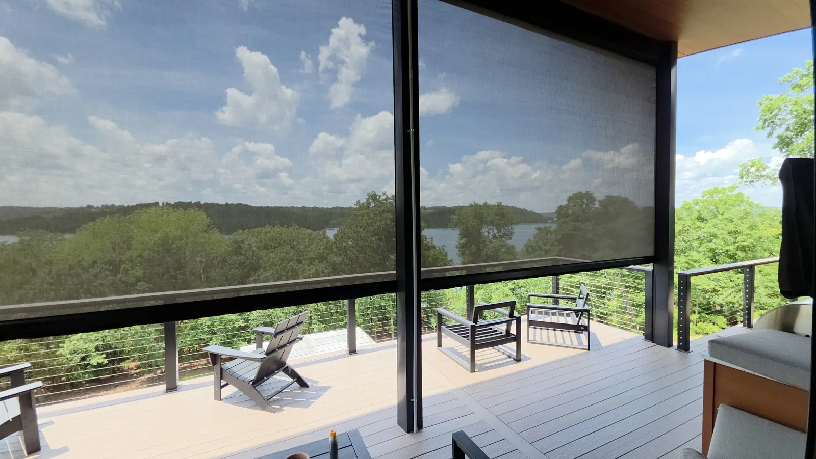 Dark see-through screen on an upper deck with cable railing and a lake view in Huckleberry Hills, Rogers, Arkansas