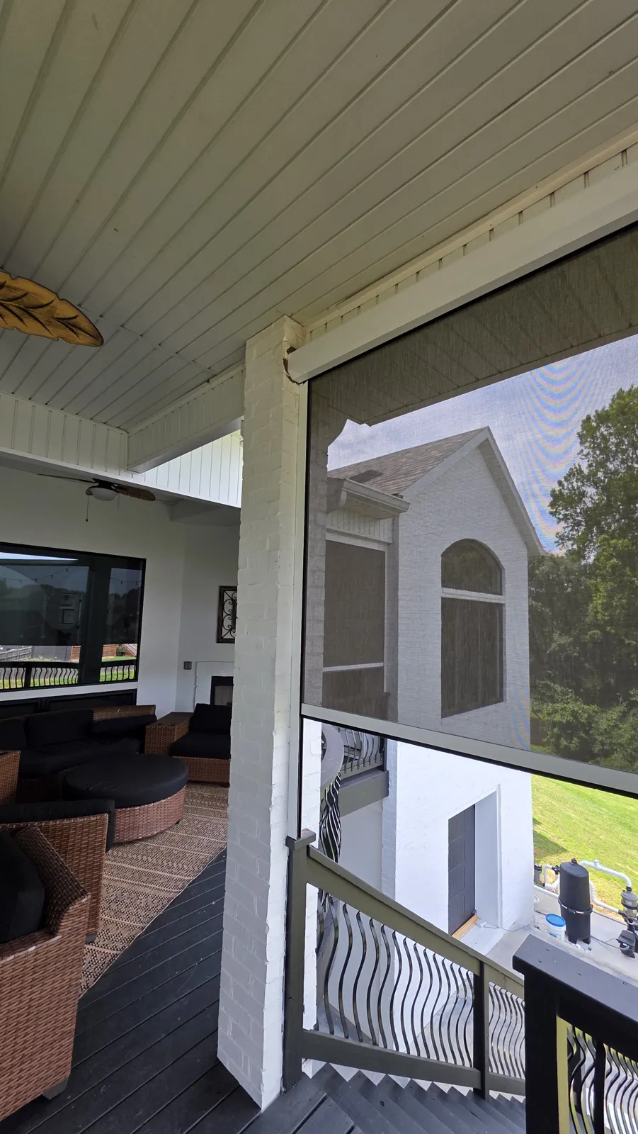 Inside view of a gray screen on a covered balcony with patio furniture in Otter Creek Estates, Cave Springs, Arkansas