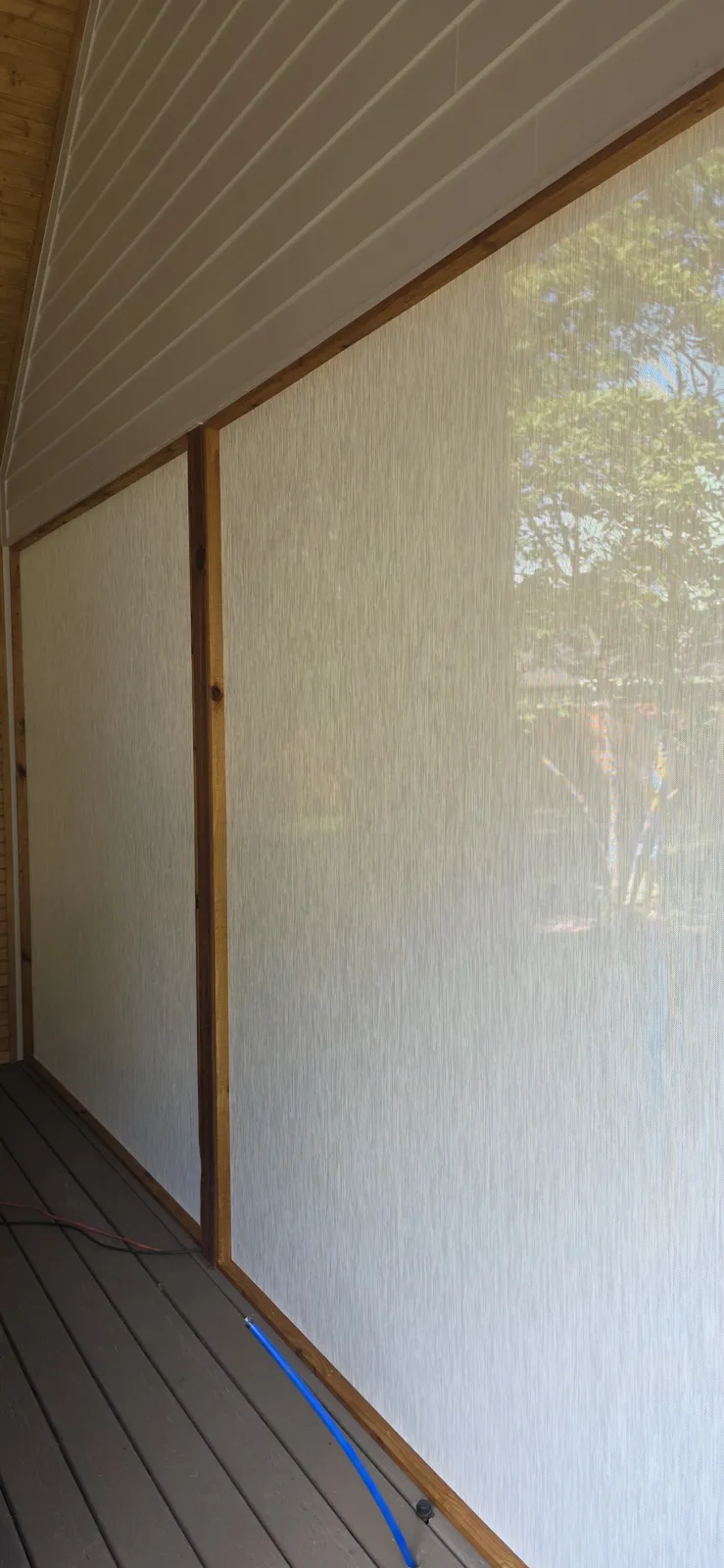 Inside view of a cream screen along a covered patio with a wood post in Suttle Estates, Springdale, Arkansas